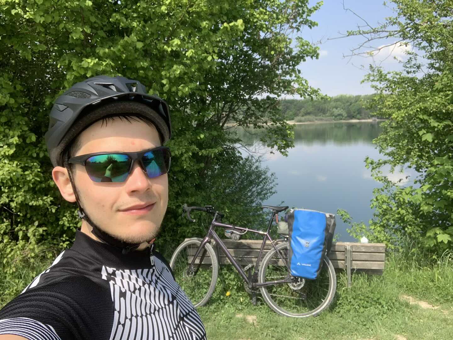 rene bergenroth in front of a lake with his bike